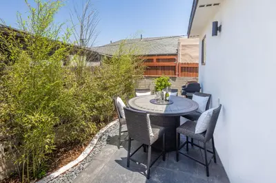 a small patio with a table and chairs at 3 Bed House with Fire Pit Table and BBQ - Downtown in San Diego