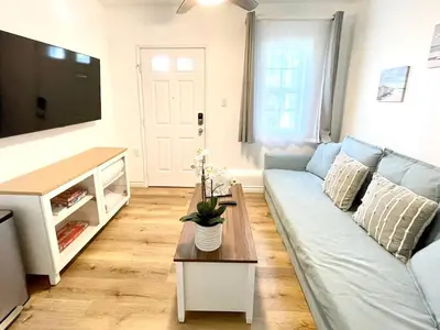 a living room with a blue couch and a table at Hidden Gem with Hot Tub and Parking - 4 Guests in San Diego