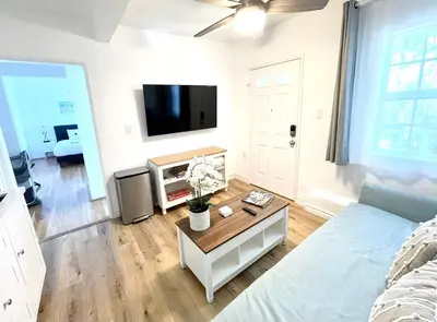 a living room with a bed and a tv at Hidden Gem with Hot Tub and Parking - 4 Guests in San Diego