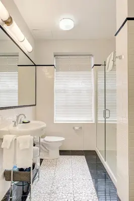 a bathroom with a toilet and a sink and a shower at Inn at the Park: San Diego Suites in San Diego