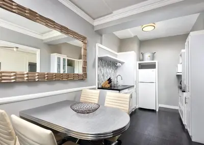 a kitchen and dining room with a table and chairs at Inn at the Park: San Diego Suites in San Diego