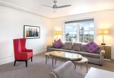 a living room with a couch and a table at Inn at the Park: San Diego Suites in San Diego