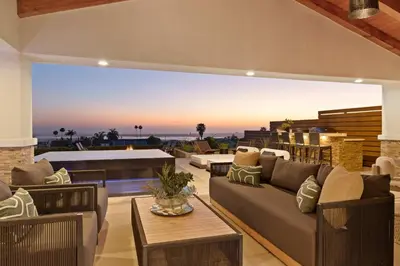 a living room with a couch and chairs and a table at Panoramic Ocean sunset Views with Heated Pool & Spa best location in San Diego