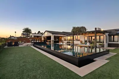 a house with a swimming pool in the yard at Panoramic Ocean sunset Views with Heated Pool & Spa best location in San Diego
