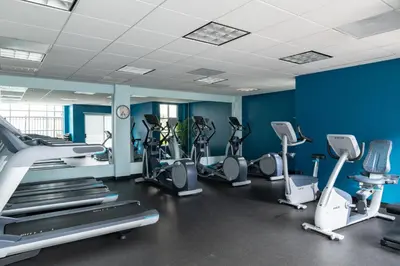 a gym with several treadmills and cardio machines at San Diego - Mission Valley Condos in San Diego