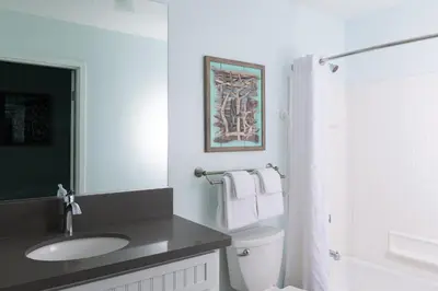 a white bathroom with a sink and a toilet at San Diego - Mission Valley Condos in San Diego