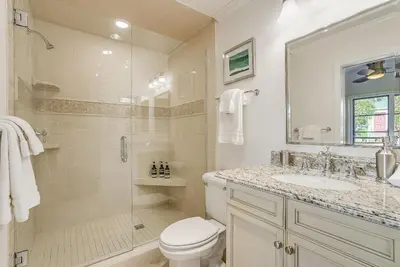 a bathroom with a shower and a toilet and a sink at Luxury, renovated, oceanfront home with incredible deck & views - dogs welcome in San Diego