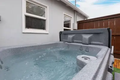 a hot tub in the backyard of a house at Beach House In The Heart Of PB in San Diego