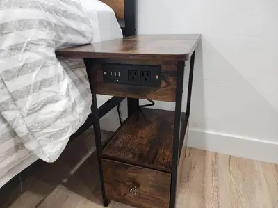 a wooden table with an alarm clock next to a bed at Beach House In The Heart Of PB in San Diego