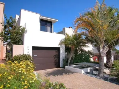 a white house with a garage and palm trees at Stunning View Mission Bay Luxury Home Private Pool in San Diego
