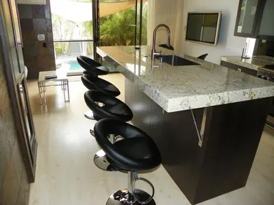 a kitchen with a row of black bar stools at Stunning View Mission Bay Luxury Home Private Pool in San Diego
