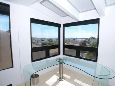 a room with a glass table in front of a window at Stunning View Mission Bay Luxury Home Private Pool in San Diego