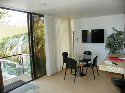 a living room with a glass table and chairs at Stunning View Mission Bay Luxury Home Private Pool in San Diego