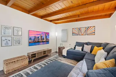 a living room with a blue couch and a table at Sweet Escape - Family Retreat - Vibrant - Spa in San Diego