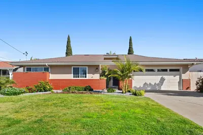 a house with a driveway and a garage at Sweet Escape - Family Retreat - Vibrant - Spa in San Diego