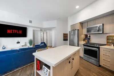a kitchen and living room with a blue couch at Park Lux PlayHouse in San Diego
