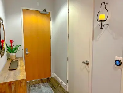 a hallway with a orange door and a plant at Italyhaus in San Diego