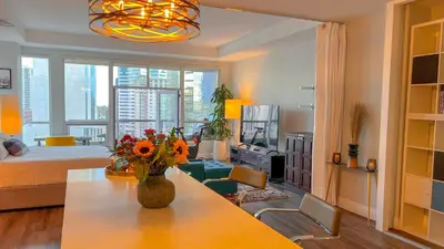 a living room with a vase of flowers on a table at Italyhaus in San Diego