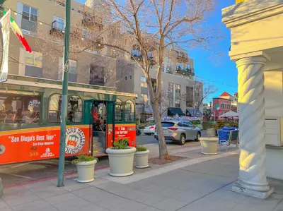 a street with a trolley on a city street at Italyhaus in San Diego