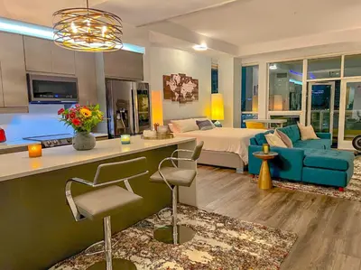 a living room with a bed and a blue couch at Italyhaus in San Diego