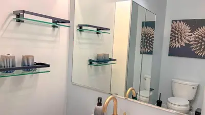 a bathroom with a mirror and a sink at Italyhaus in San Diego