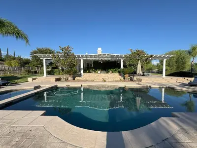 a swimming pool in a courtyard with a building at Temecula Wine Country Villa in Temecula