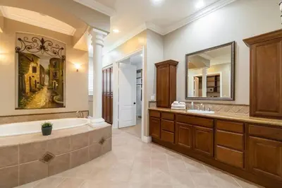 a bathroom with a tub and a large mirror at Temecula Wine Country Villa in Temecula