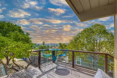 a balcony with a table and a view of the water at Avoyer One Bedroom Guesthouse - La Mesa in La Mesa
