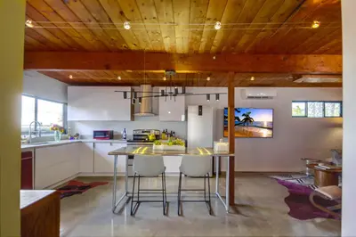 a kitchen with a table and chairs in a room at Avoyer One Bedroom Guesthouse - La Mesa in La Mesa