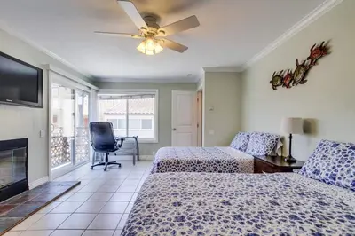 a bedroom with two beds and a ceiling fan at Mission Beach Townhome Getaway in San Diego