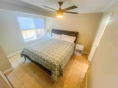 a bedroom with a bed and a ceiling fan at Mission Beach Townhome Getaway in San Diego