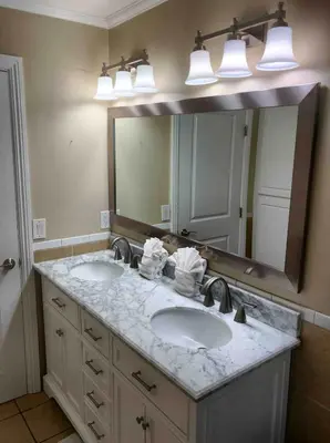 a bathroom with two sinks and a large mirror at Mission Beach Townhome Getaway in San Diego