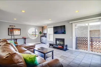 a living room with a couch and a table at Mission Beach Townhome Getaway in San Diego