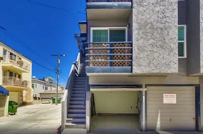 a building with a staircase leading to a garage at Mission Beach Townhome Getaway in San Diego
