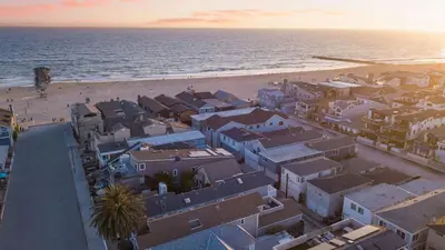 an aerial view of a beach with houses and the ocean at Surfrider II by AvantStay Walk to the Beach Balcony in Newport Beach