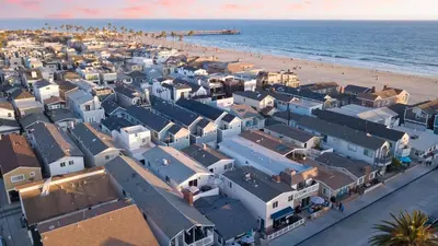 an aerial view of a beach with white houses at Surfrider II by AvantStay Walk to the Beach Balcony in Newport Beach