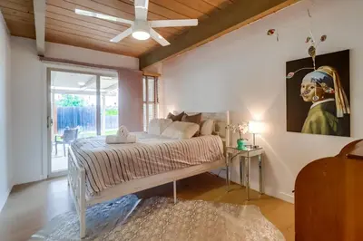 a bedroom with a bed and a painting on the wall at The Helix House - Pool & Mountain Views in La Mesa