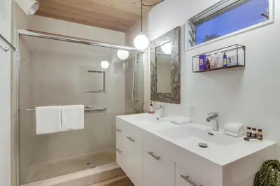 a white bathroom with a sink and a shower at The Helix House - Pool & Mountain Views in La Mesa