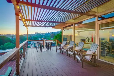 a deck with chairs and a table on a balcony at The Helix House - Pool & Mountain Views in La Mesa