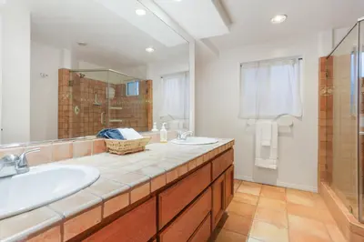 a bathroom with a sink and a mirror at La Playa - Charming Bayside Bungalow in San Diego