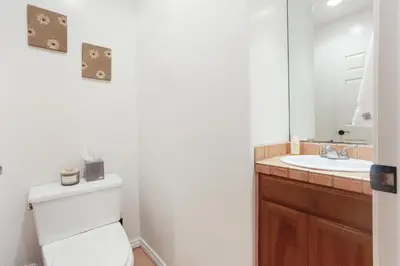 a bathroom with a toilet and a sink at La Playa - Charming Bayside Bungalow in San Diego
