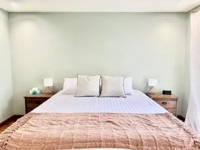 a bedroom with a large bed with two lamps at Canyon Breeze - Private Home with Hot Tub & Views in San Diego