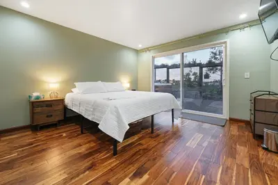 a bedroom with a bed and a large window at Canyon Breeze - Private Home with Hot Tub & Views in San Diego