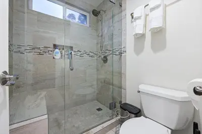 a bathroom with a toilet and a glass shower at Canyon Breeze - Private Home with Hot Tub & Views in San Diego