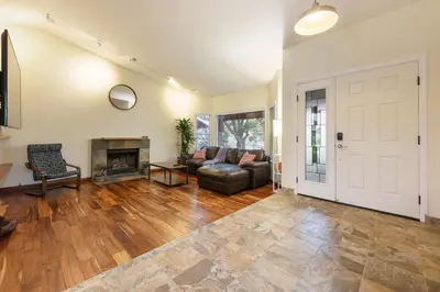 a living room with a couch and a fireplace at Canyon Breeze - Private Home with Hot Tub & Views in San Diego