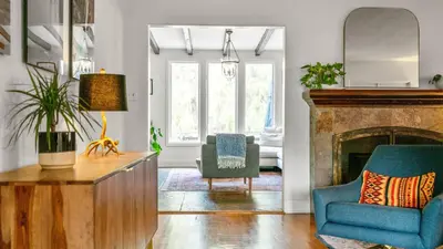 a living room with a blue chair and a fireplace at Chic Kensington Home - Hot Tub & Canyon Views in San Diego