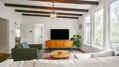 a living room with a couch and a tv at Chic Kensington Home - Hot Tub & Canyon Views in San Diego