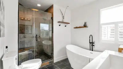 a white bathroom with a tub and a shower at Chic Kensington Home - Hot Tub & Canyon Views in San Diego