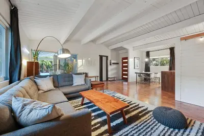 a living room with a couch and a table at Agua Dulce - Mid Century Oasis - Pool &Hot Tub in Spring Valley