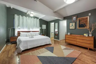 a bedroom with a large bed and a dresser at Agua Dulce - Mid Century Oasis - Pool &Hot Tub in Spring Valley